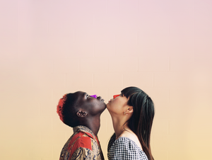 Two women with signature Nöz sunscreen on, staring upwards chin to chin.