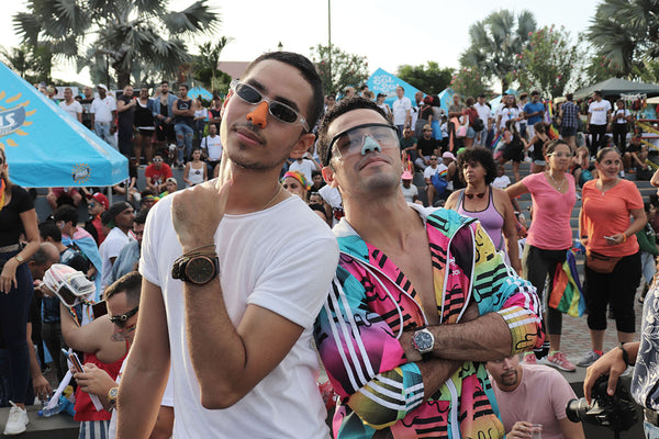 two friends at a musical event posing with Nöz sunscreen on their noses.